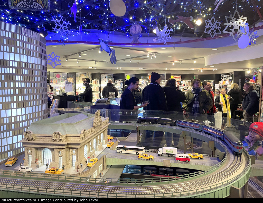 Polar Express Steam Locomotive pulling a set of former NY Central Cars around the Grand Central Terminal Building